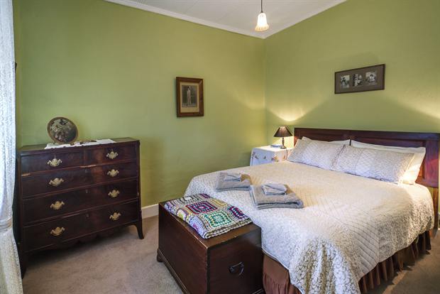 Cottage 8 — a cottage bedroom made up with linen, quilts and towels