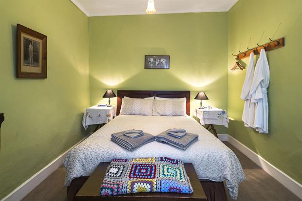 Cottage 8 — a cottage bedroom made up with linen, quilts and towels