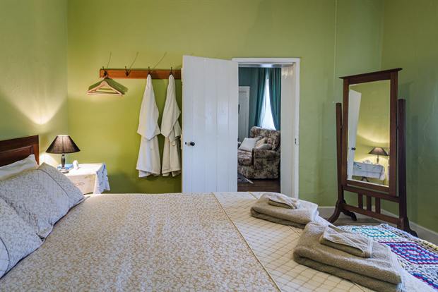 Cottage 8 — a cottage bedroom made up with linen, quilts and towels
